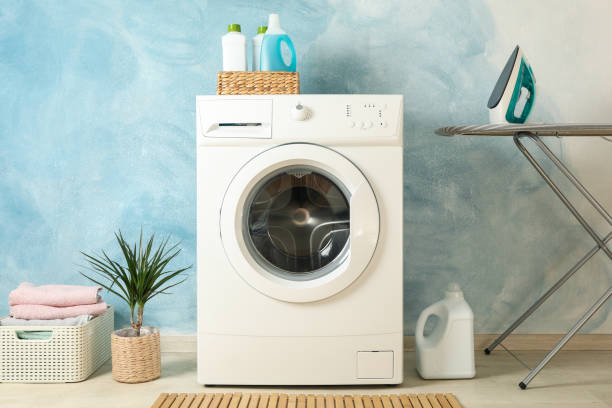istock Laundry room with washing machine against blue wall 1199955373