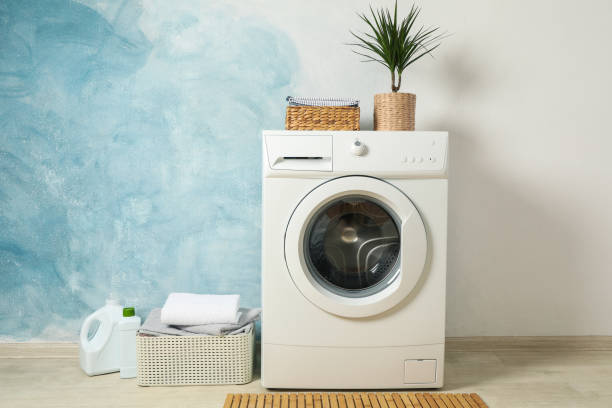 istock Laundry room with washing machine against light blue wall, space for text 1199955402