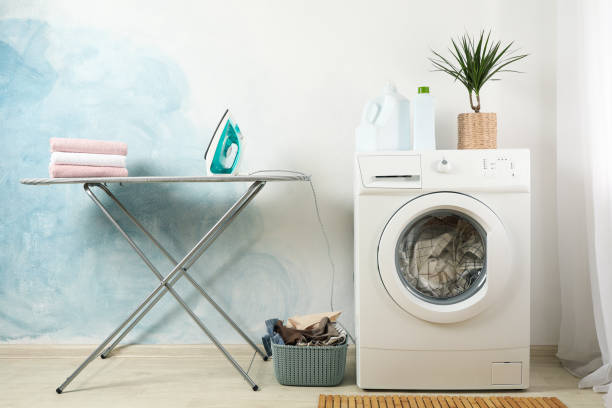 istock Laundry room with washing machine against light blue wall 1199955422