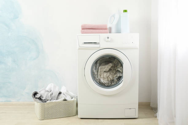 istock Laundry in a washing machine and in basket, space for text 1199955506