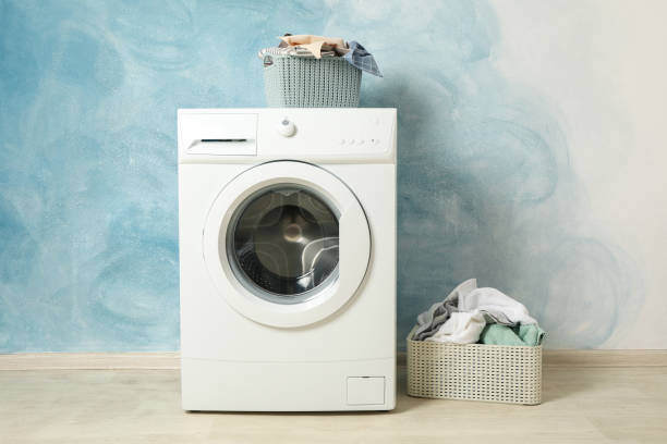 istock Laundry room with washing machine against blue wall 1199955646