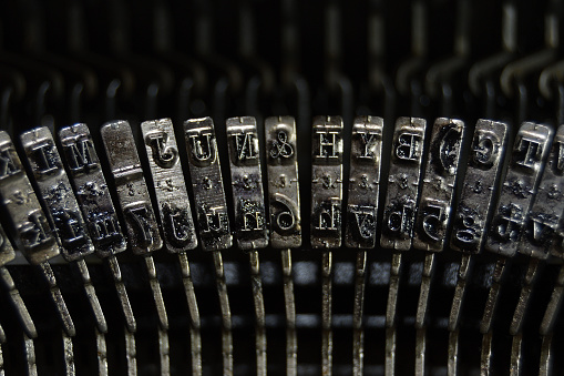 Letters and numbers in the typo keys of a old qwerty typewriter