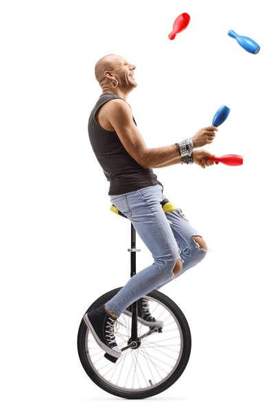 istock Bald man juggling and riding a unicycle 1199956592