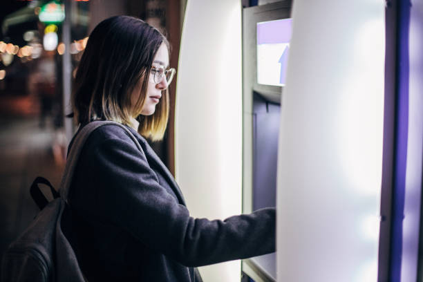 istock Withdrawing money from ATM machine 1199958020