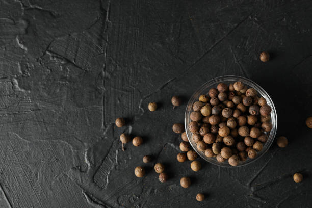 istock Bowl with peppercorns on black background, top view 1199958276