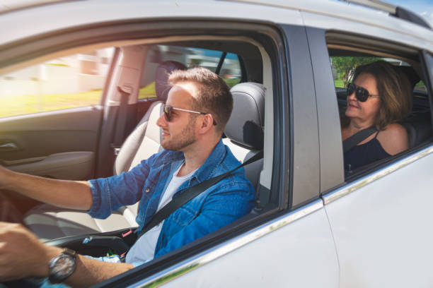 istock Driver inside a car with a woman as a passenger. 1199958691