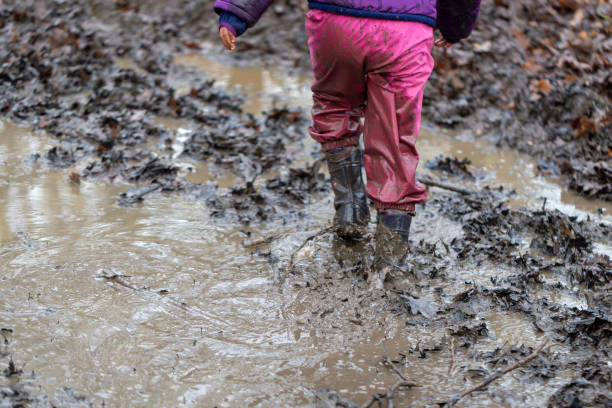 istock Young children playing in a mud puddle 1199959403