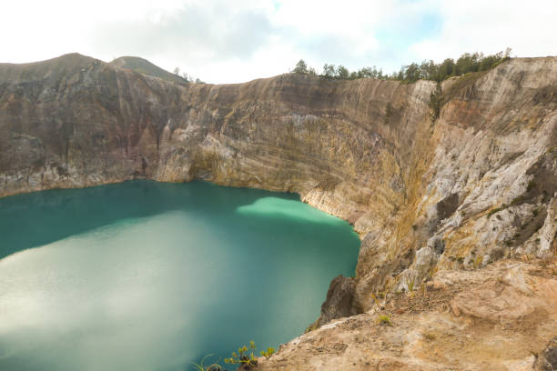 istock Kelimutu - Close up on turquoise colored volcanic lake 1199960254