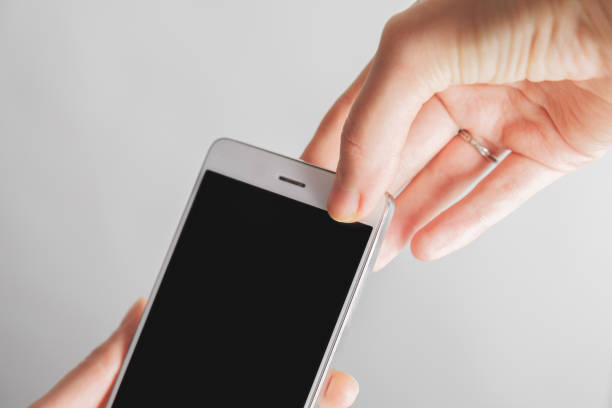 istock Thumb covers up the front facing camera of a smartphone. 1199960352