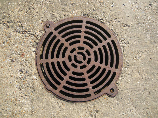 istock Sewer manhole located in a concrete slab 1199960782
