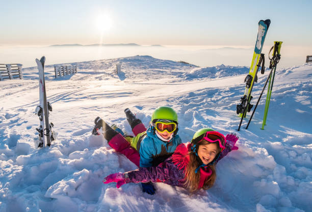 Cute kids is playing airplain on snow