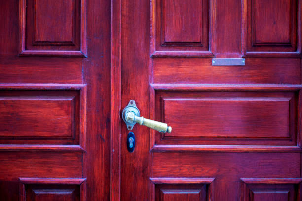 Mahogany wooden entrance door close-up, with metal nameplate template.
