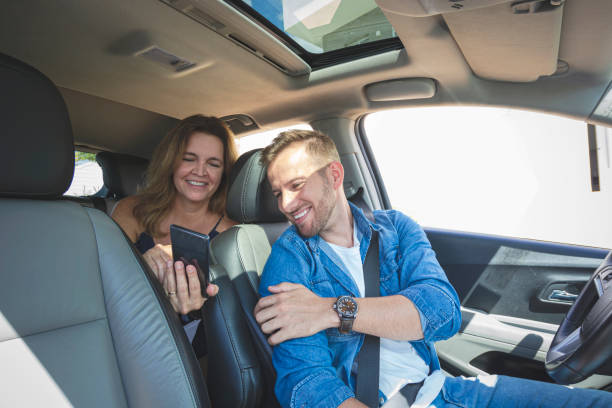 istock Driver inside a car with a woman as a passenger. 1199963510