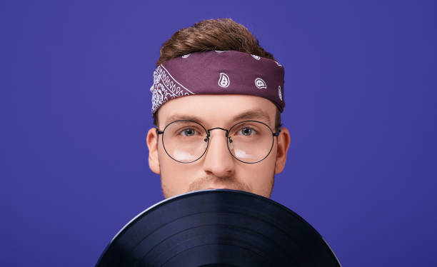 istock Calm guy with glasses and a bandana with a record player. 1199964098