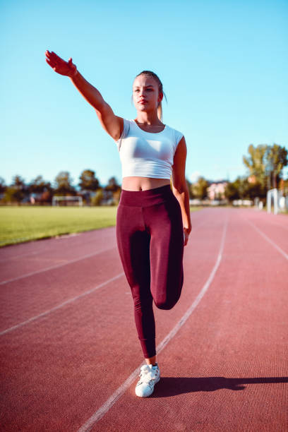 istock Female Athlete Stretching Before Running On Track 1199965010