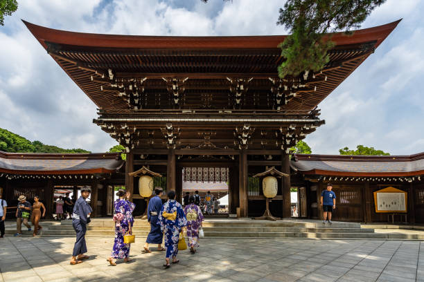 Entrance to Meiji Jingu, a famous Shinto shrine in Tokyo Boys and girls in traditional dress entering to Meiji Jingu shrine dedicated to the deified spirits of Emperor Meiji.i. Tokyo, Japan, August 2019 tokyo harajuku stock pictures, royalty-free photos & images