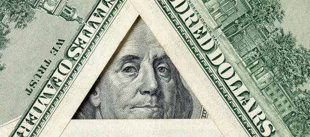 istock Triangle made of $100 bills with Benjamin Franklin inside 1199967820