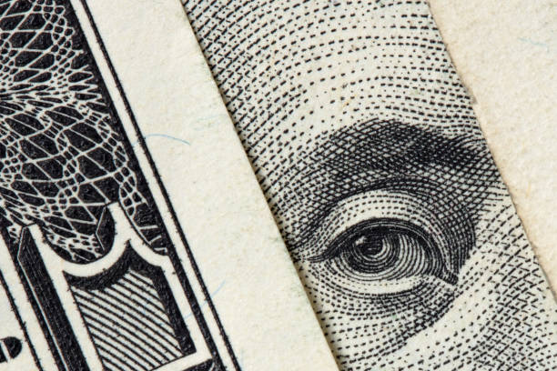 Benjamin Franklin looking from $100 bills stock photo
