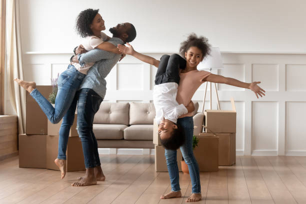 istock Funny mixed race family celebrating moving day. 1199968687