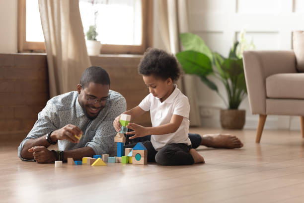 istock Black happy man playing with small cute son. 1199968709