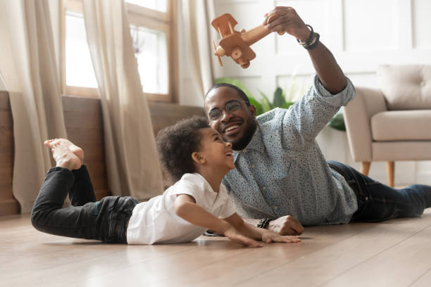 istock African american father playing with cute son. 1199968710