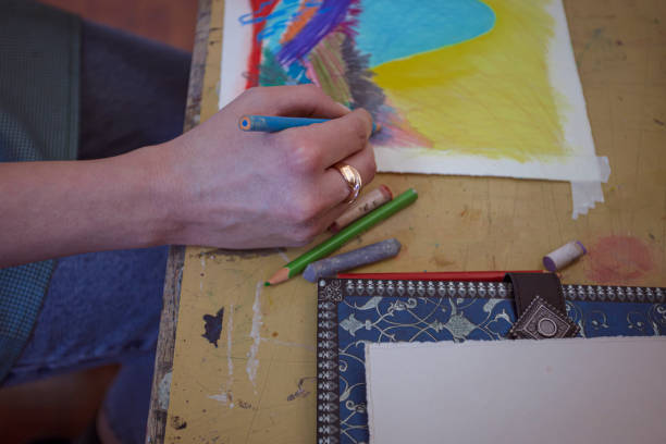 istock Artist's hands working on a colorful drawing 1199969154
