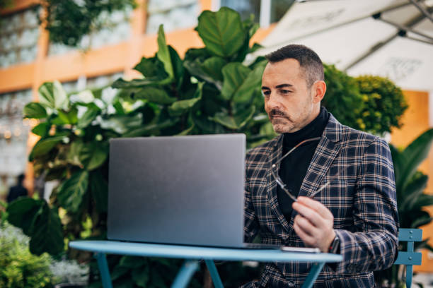 istock Mature elegant businessman is using laptop 1199969193