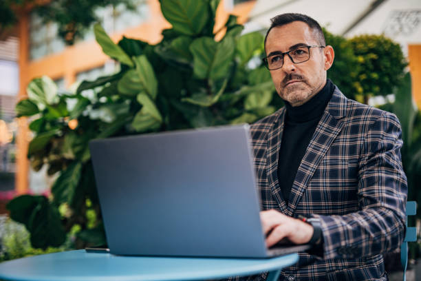 istock Mature businessman is using laptop 1199969309