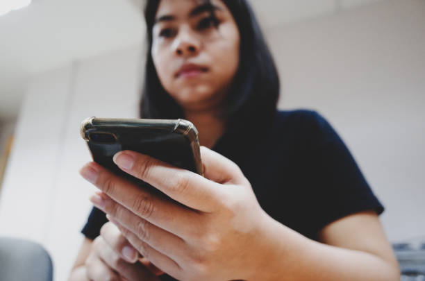 istock young women working from home using smart phone and laptop 1199970438