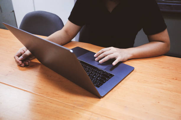 istock Young woman working on laptop at home 1199970451