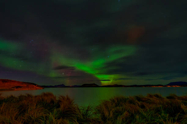 istock Northern lights (Aurora borealis) reflection across a lake in Iceland 1199970589