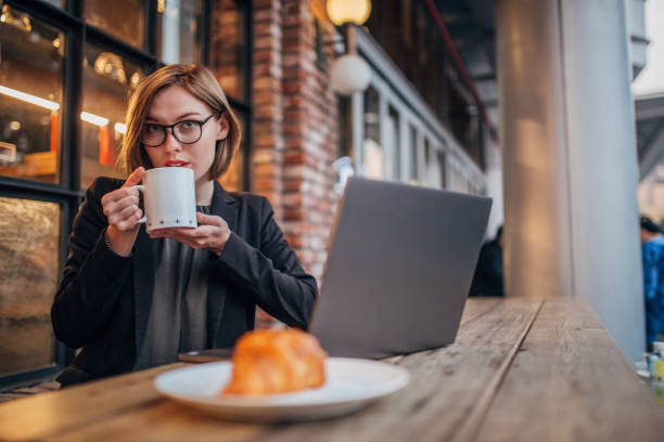 istock Pretty young woman is having coffee 1199971350
