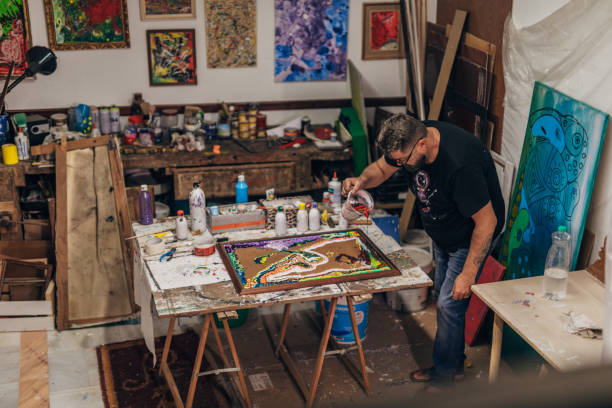 istock Creative man painting in art studio 1199974460