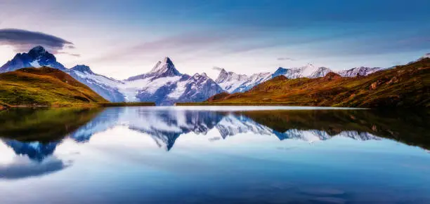 Panoramic view of the Mt. Schreckhorn and Wetterhorn. Popular tourist attraction. Dramatic and picturesque scene. Location place Bachalpsee in Swiss alps, Grindelwald valley, Europe. Beauty world.