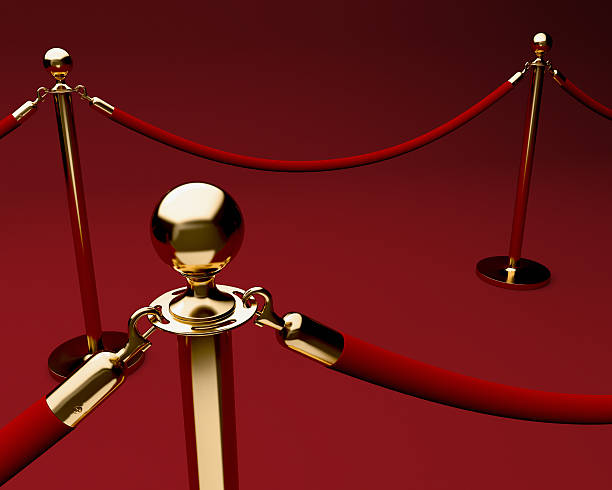 Red carpet with velvet rope and stanchions. Red carpet with velvet rope barrier and shiny brass stanchions roped off stock pictures, royalty-free photos & images