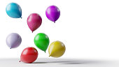 Colorful balloons floating on white background.