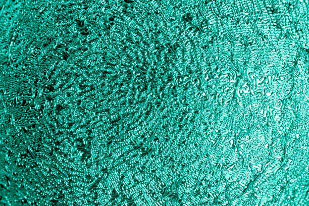istock Unusual shiny surface close-up. Turquoise background for sites and layouts. 1199985569