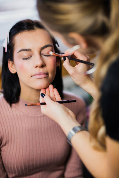 istock Woman putting eye shadow to her makeup model 1199986148