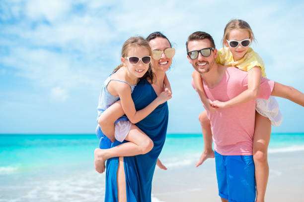 istock Happy family on the beach during summer vacation 1199987809