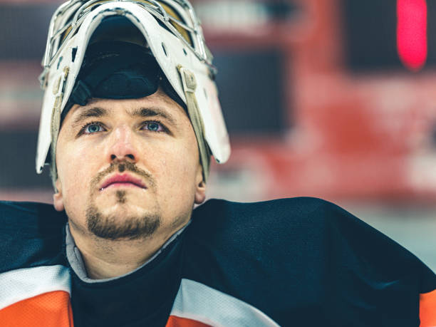 Young Caucasian male Pro Hockey goalie at the training at the hockey arena.