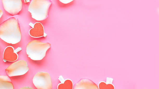 istock Gentle white rose petals on pink background. Flat lay, top view, copy space. Valentines Day or wedding greeting card 1199989052