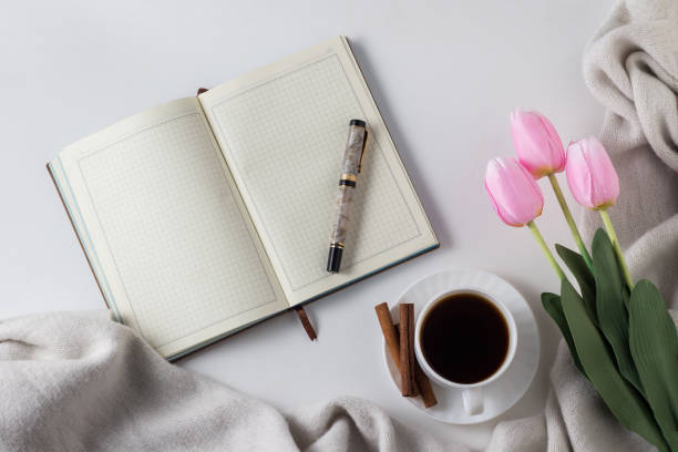 istock Open Diary, Pen, Cup With Hot Coffee, Scarf, Tulips on the White Background. Spring Concept. Flat lay, top view 1199989825
