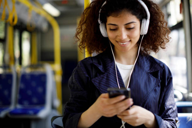 istock Smiling young woman commuting by public transport 1199990458