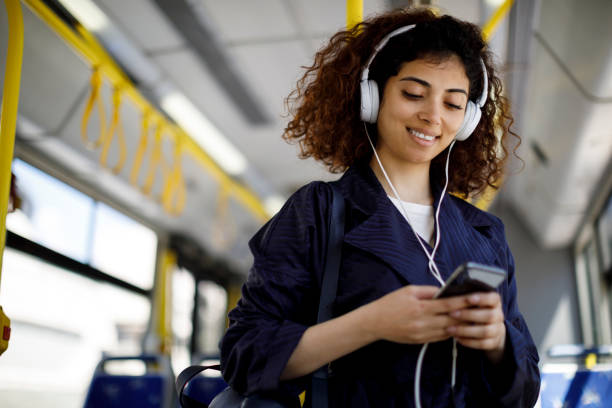 istock Smiling young woman commuting by public transport 1199990470