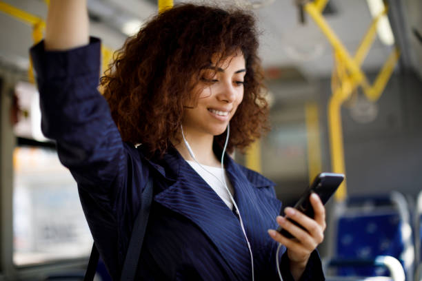 istock Young woman using mobile phone while travelling by bus 1199991107