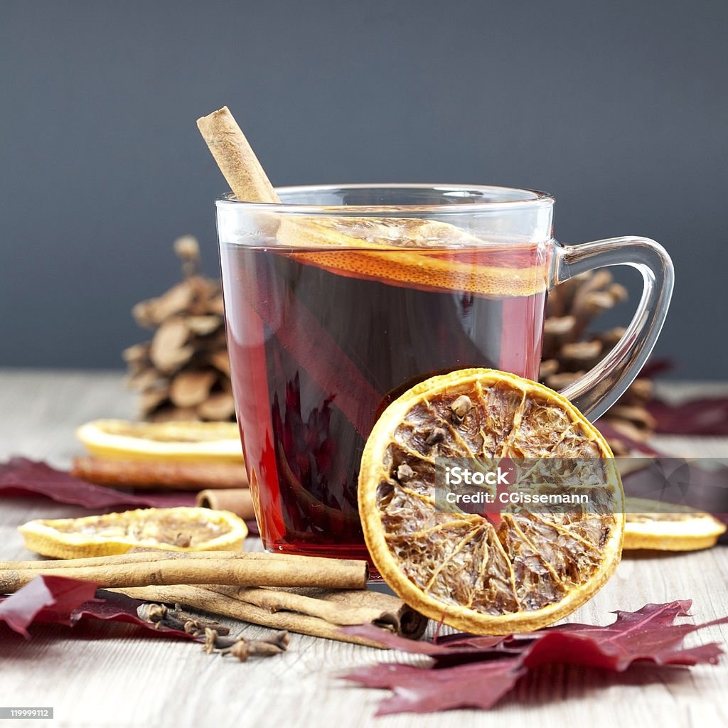 Glass cup of mulled wine with other ingredients a glass of mulled wine decorated with cinnamon and orange Advent Stock Photo