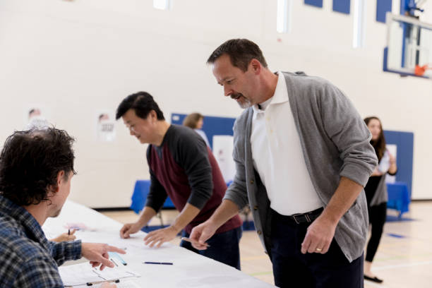 istock Two mature men get information about voting 1199991170