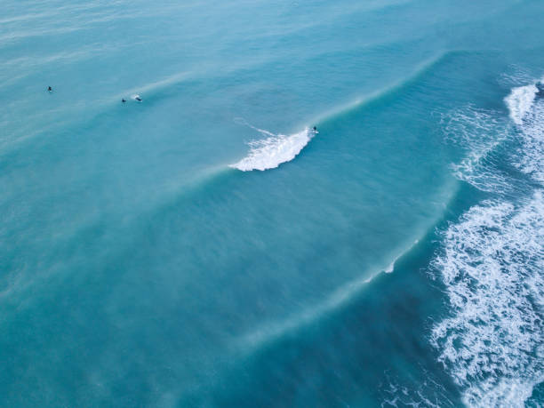 istock Sea with foam and surfers 1199992217