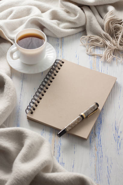 istock Cup with Coffee, Notepad on the White Wooden Table. Concept of Spring 1199993304