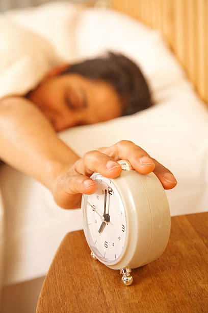 istock Woman switching off alarm 119999337